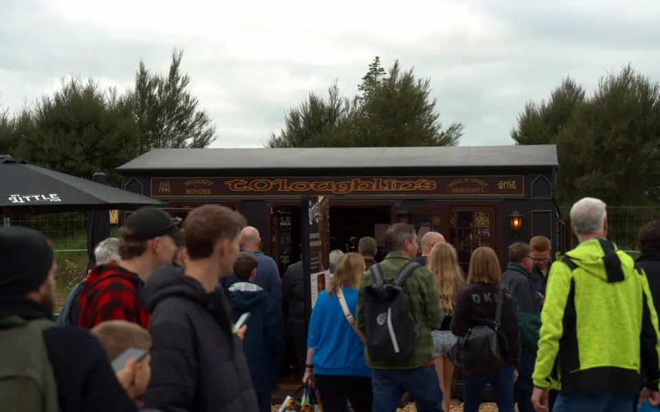Crowd gathered around a My Little Pub build on a trade show ground